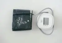A digital sphygmomanometer on a white background, used for measuring blood pressure.