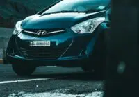 Front view of a Hyundai vehicle parked on an asphalt road.