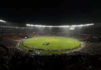 A captivating night cricket match with a large crowd at Narendra Modi Stadium in Ahmedabad, India.