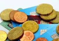 Close-up image of Euro coins and credit cards representing modern financial transactions.