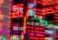 Dynamic forex trading concept with currency symbols and candlestick chart illuminated on screen.