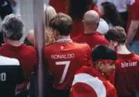 Football enthusiasts gather in team jerseys, celebrating their passion for the game outdoors.