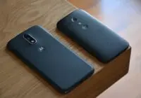 Two Motorola smartphones placed on a wooden table with natural lighting.