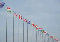 A row of international flags on flagpoles symbolizing global unity and diplomacy.