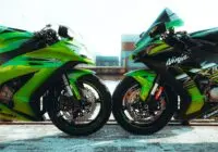 Close-up of two Kawasaki Ninja sports bikes in vibrant green, showcased side by side outdoors.