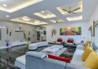 Spacious contemporary living room with elegant furniture and vibrant artwork in a Mumbai home.