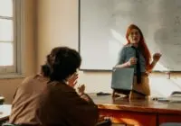 Teacher engages with student during a lesson at a Buenos Aires university classroom.