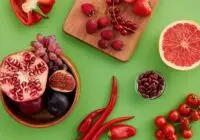 A vibrant display of fresh fruits and vegetables on a green surface.