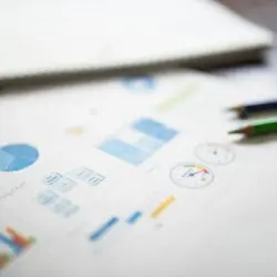 FD vs म्यूचुअल फंड: कौन सा है आपके लिए बेहतर निवेश विकल्प? 2 Illustration of a business financial report featuring various charts and graphs on paper.